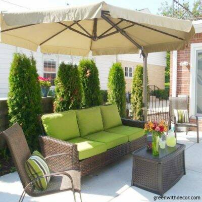 This backyard looks awesome! I love the big couch and umbrella! How relaxing! | Green With Decor – 5 top priorities when planning a backyard oasis
