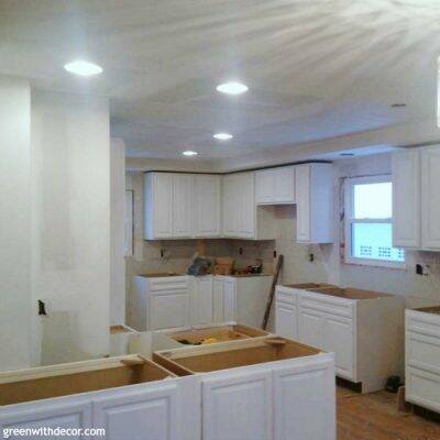 White cabinets installed in the kitchen! If you need a lower cabinet for a tight spot, think about using an upper cabinet.