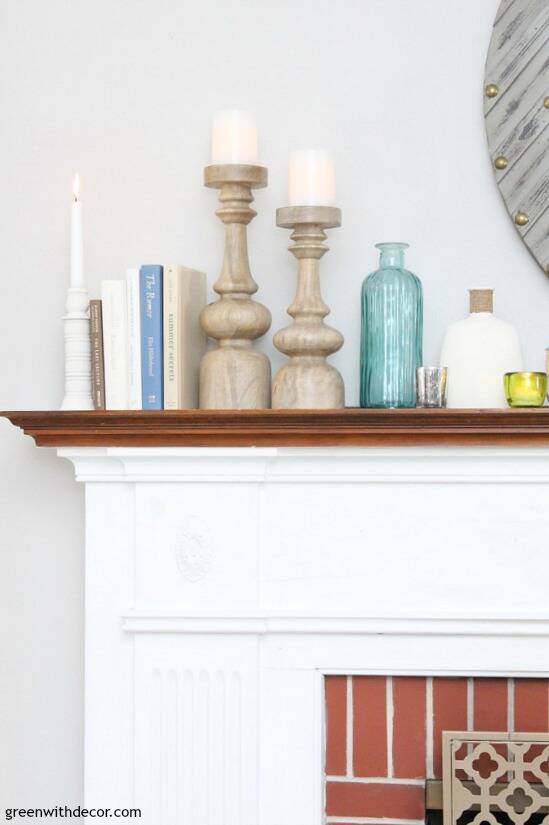 A simple coastal mantel using wood candlesticks, books and glass vases. Love those wood pillar candlesticks! Such easy mantel decorating ideas especially if you have a long mantel!
