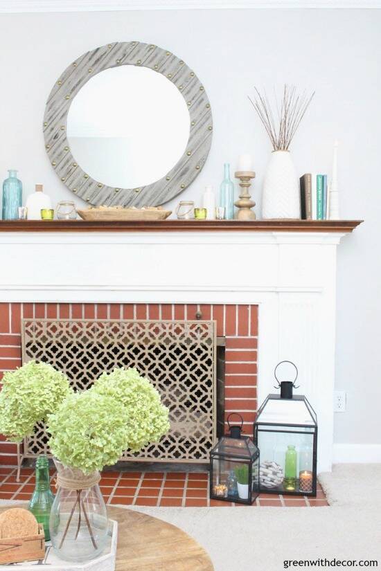 A simple coastal mantel using wood candlesticks, books and glass vases - so easy!