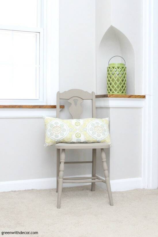 Gray hallway with painted gray chair, patterned pillow and green lantern in a telephone nook