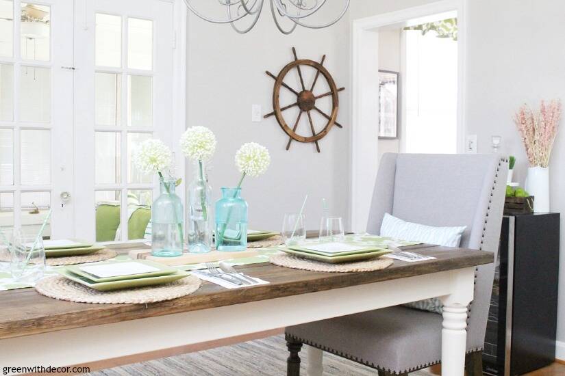 A coastal dining room with gray walls and a wood farmhouse dining table