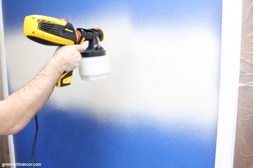 A Wagner FLEXIO paint sprayer being used to paint an interior wall.