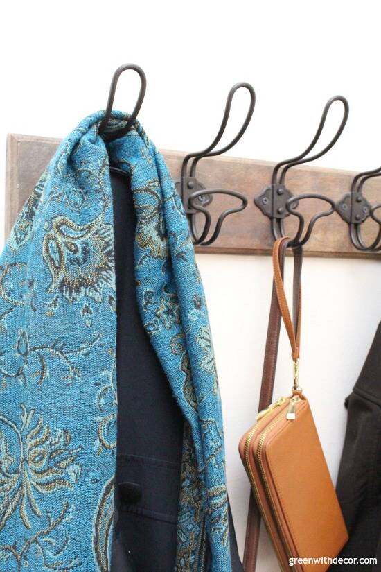 A close up photo of a scarf and jacket hung on a hook