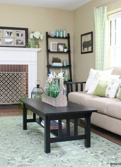 A pretty neutral tan paint color - Sherwin Williams' Camelback. It looks great in this coastal living room, pairs so well with aqua and green decor accessories and that tan couch!