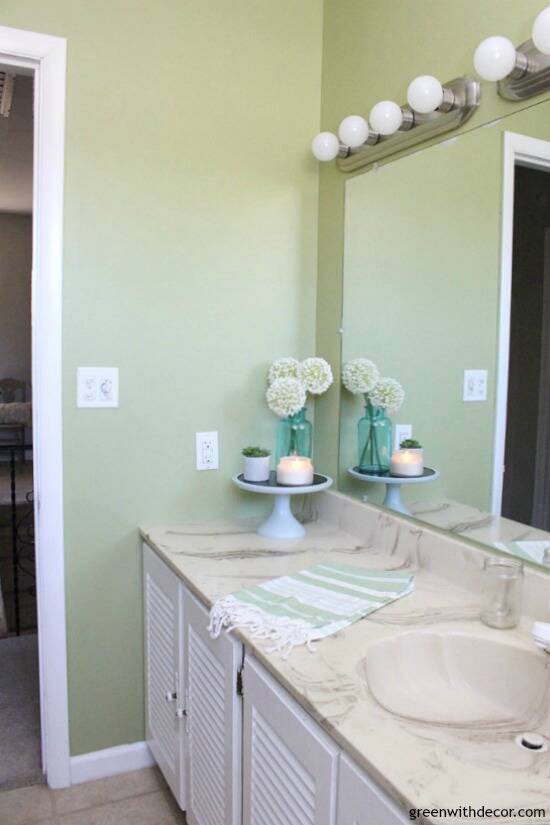 Rental bathroom reveal - green and white bathroom with pretty decor even if you can't remodel!