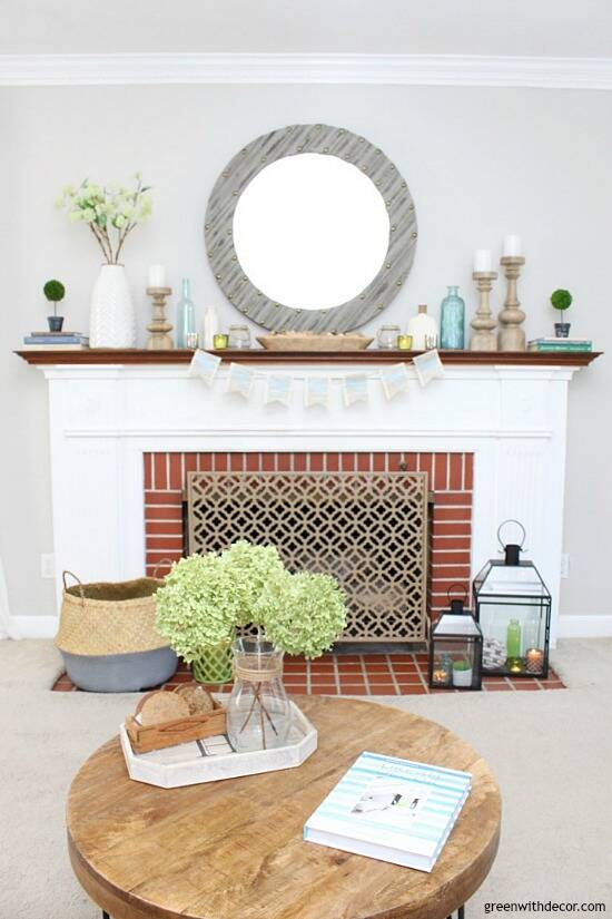 An easy blue and green spring mantel - love the glass vases, wood candlesticks, big gray mirror and bread bowl. The pieces all come together so easily for a cohesive, spring look!