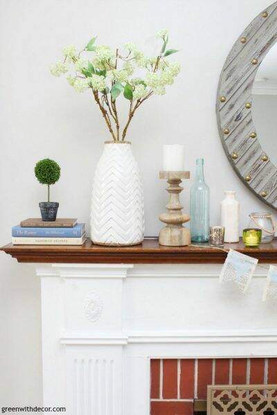 An easy blue and green spring mantel - that white and wood vase with the green hydrangeas is so pretty and perfect for spring! Love it with the little topiary and the bread bowl!