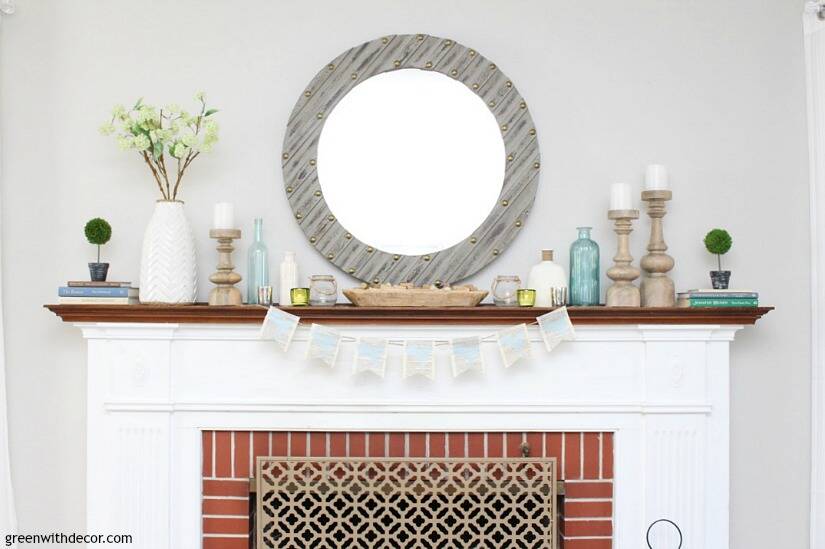 An easy blue and green spring mantel - love the glass vases, wood candlesticks, big gray mirror and the bread bowl. The pieces all come together so easily for a cohesive, spring look!