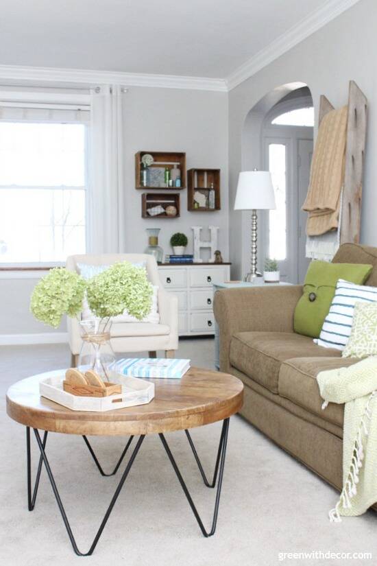 Round wood and metal coffee table in a coastal living room