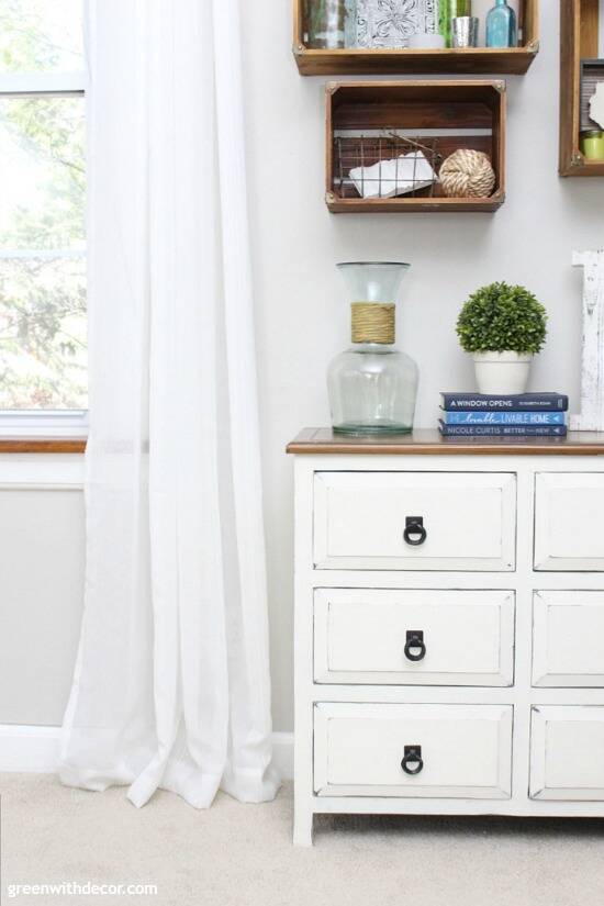 Pretty spring decorating ideas. Love this white chest with the wood crates as wall shelves! And that potted boxwood is faux, who would guess?!