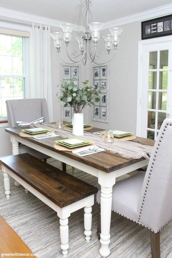 A coastal farmhouse dining room with a big wood and white table and gray walls