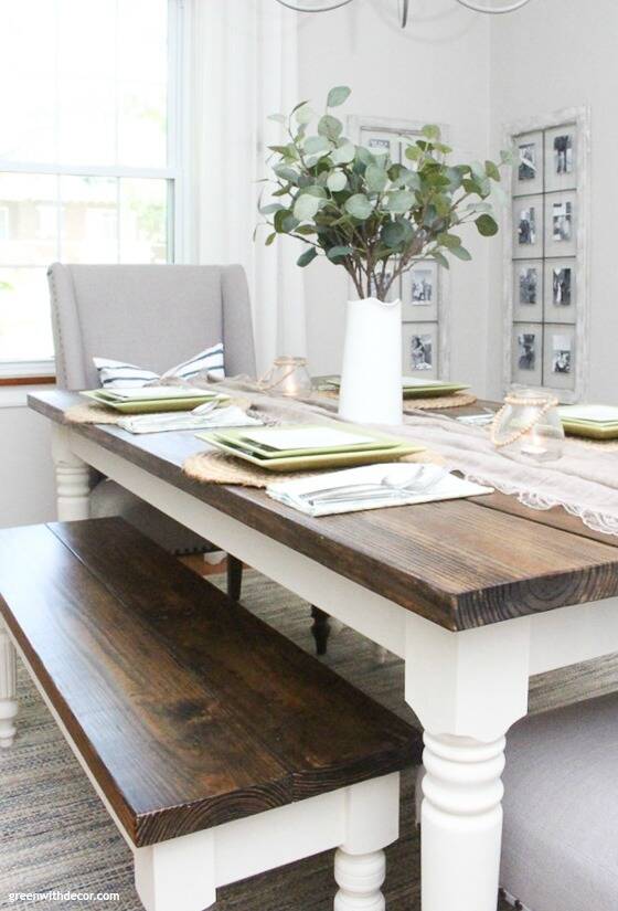 A coastal farmhouse dining room with a big wood and white table, gray walls and a gray chair