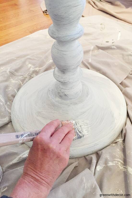 A white pedestal table being painted white