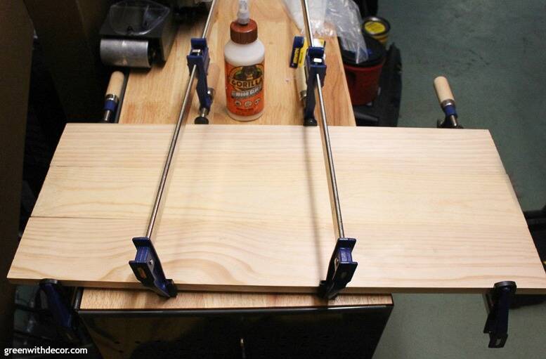 Wood pieces glued and clamped together for a DIY picture frame with a burned wood finish