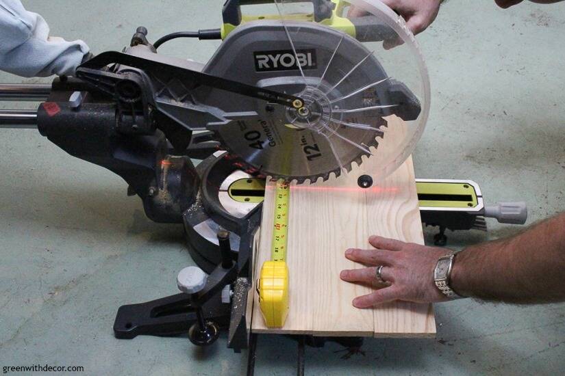 A saw cutting wood for a DIY picture frame with a burned wood finish