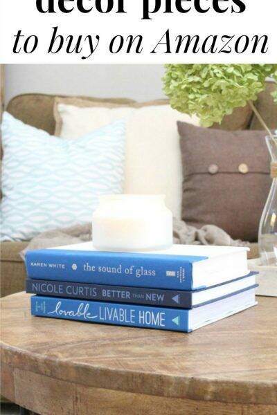 Blue books and white candle with text overlay, "Pretty home decor pieces to buy on Amazon"