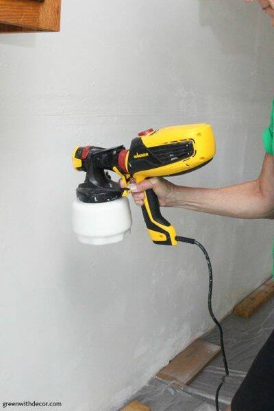 Painting garage walls with a paint sprayer – in process picture