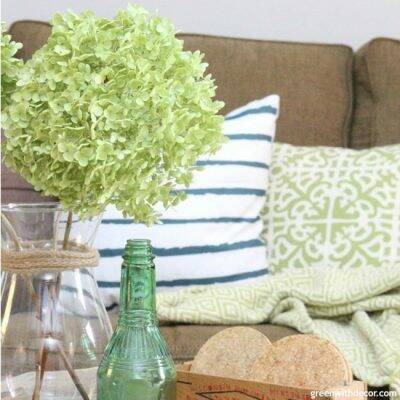 How to find your decorating style – a coastal living room with green hydrangeas and a striped pillow