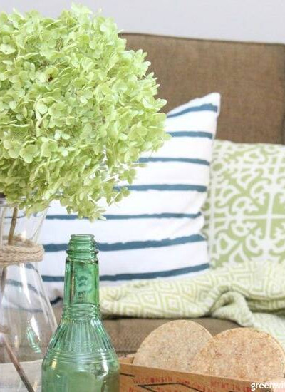 How to find your decorating style – a coastal living room with green hydrangeas and a striped pillow