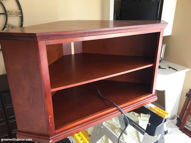 A brown wood TV stand before being painted up on sawhorses