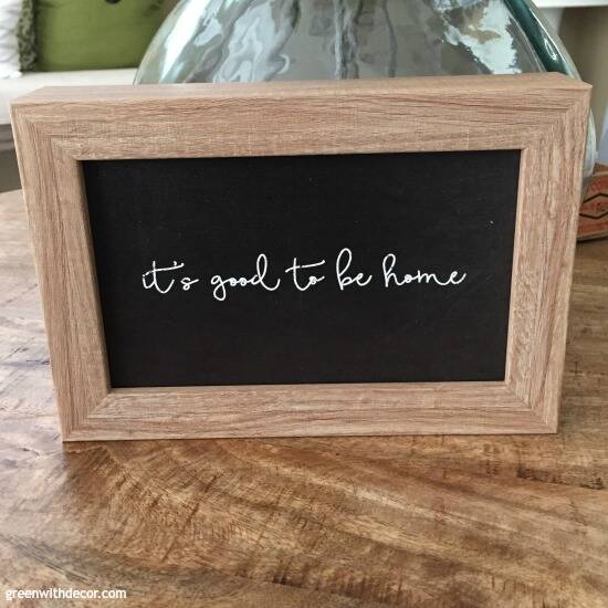 Black and wood sign, "It's good to be home"