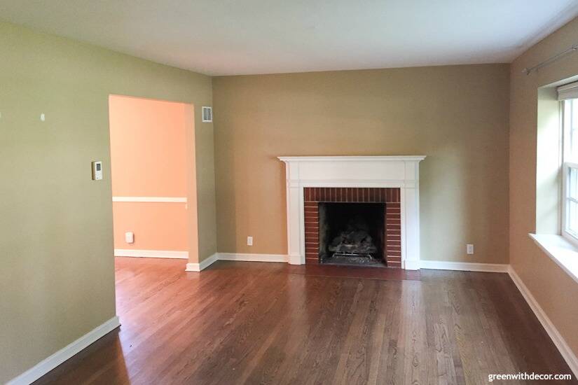 Tan living room with fireplace before built-in bokoshelves