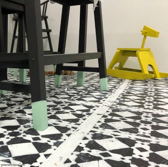 Black and white tile floor with black furniture and yellow rocking horse