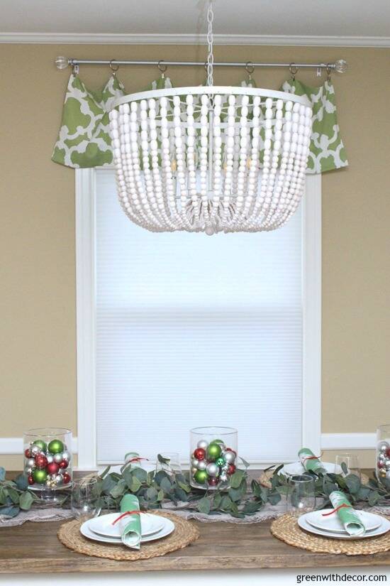 Wood beaded chandelier above a Christmas centerpiece