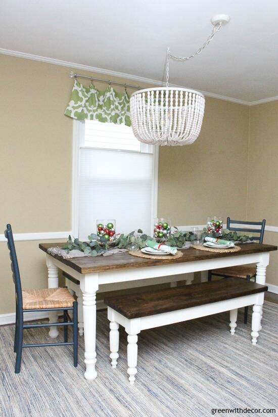 Farmhouse table with Christmas centerpiece full of eucalyptus and ornaments