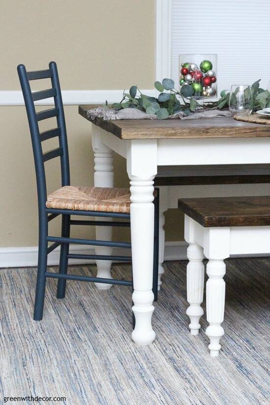 White and wood farmhouse table and bench with Christmas centerpiece