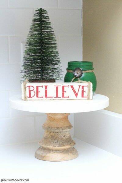 Christmas cake platter with tree, candle and believe sign