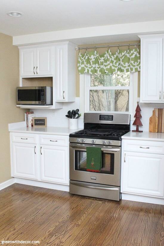 White kitchen with stainless steel stove decorated for Christmas