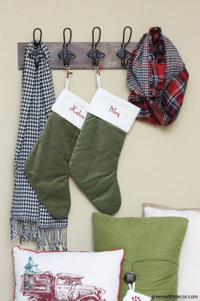 Christmas mudroom with green stockings and wood hooks