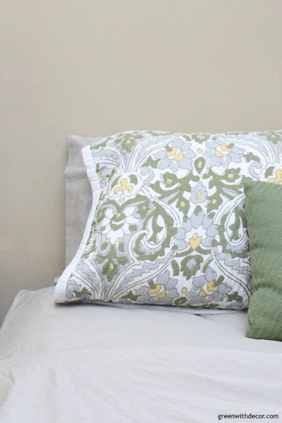Green, blue and white sham pillow with khaki sheets