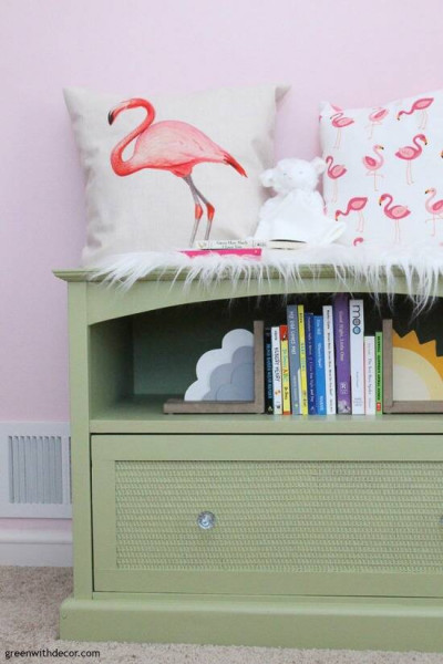 A green TV stand turned book storage for a nursery