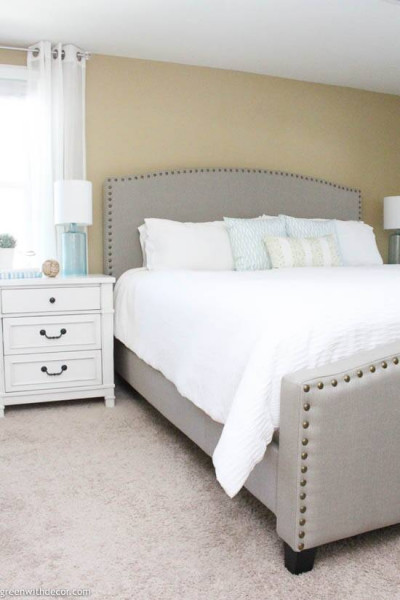 Coastal bedroom with gray headboard and white bedding