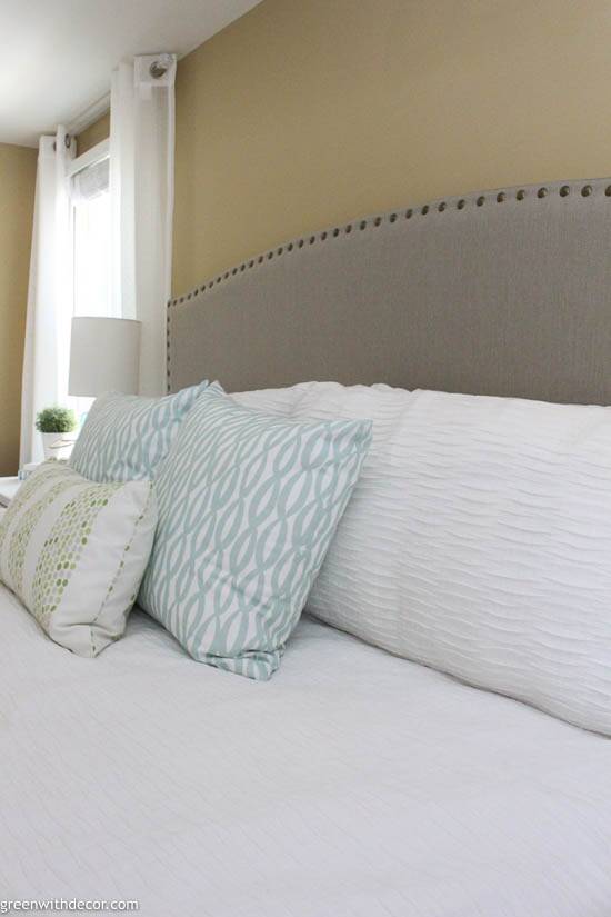 Coastal bedroom with upholstered headboard and pillows