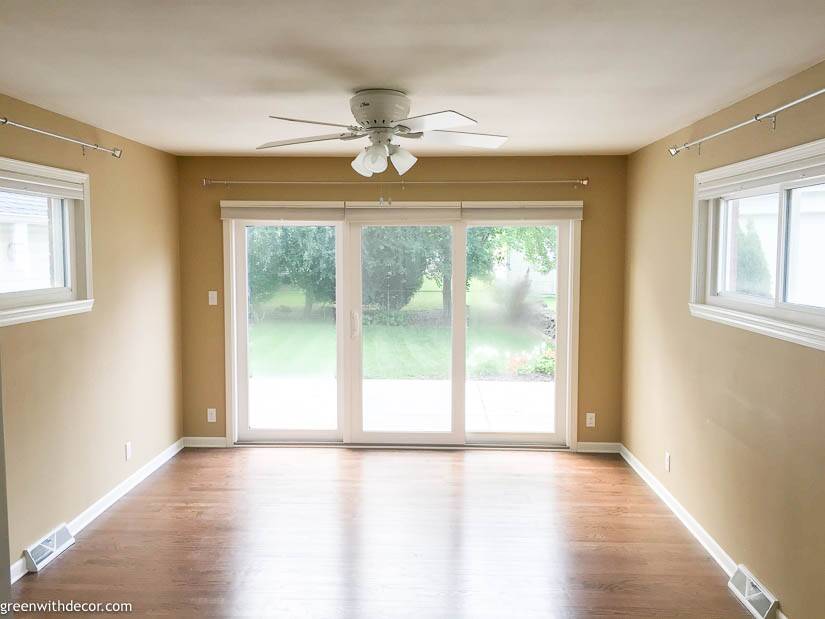 Tan room with white trim, hardwood floors and patio doors