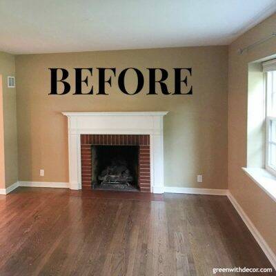 Tan living room with white mantel, red brick fireplace and hardwood floors