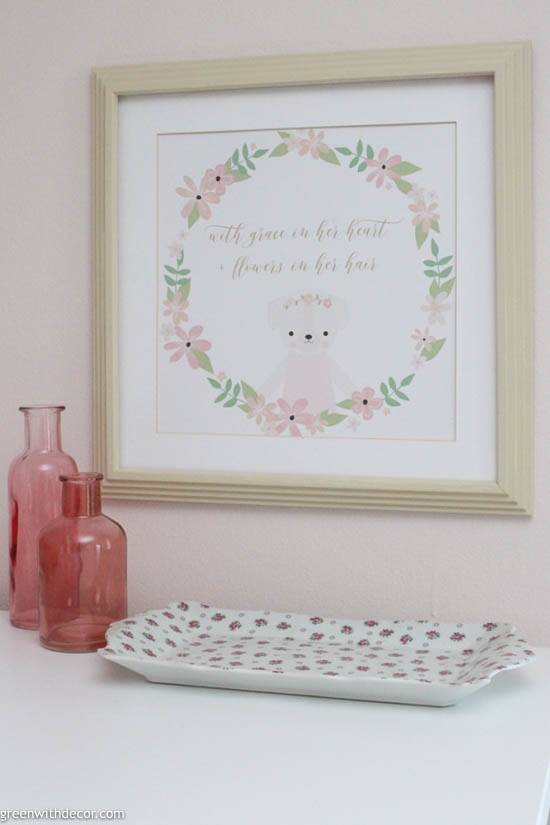 Pink, green and white nursery artwork with pink bottles and flowered tray
