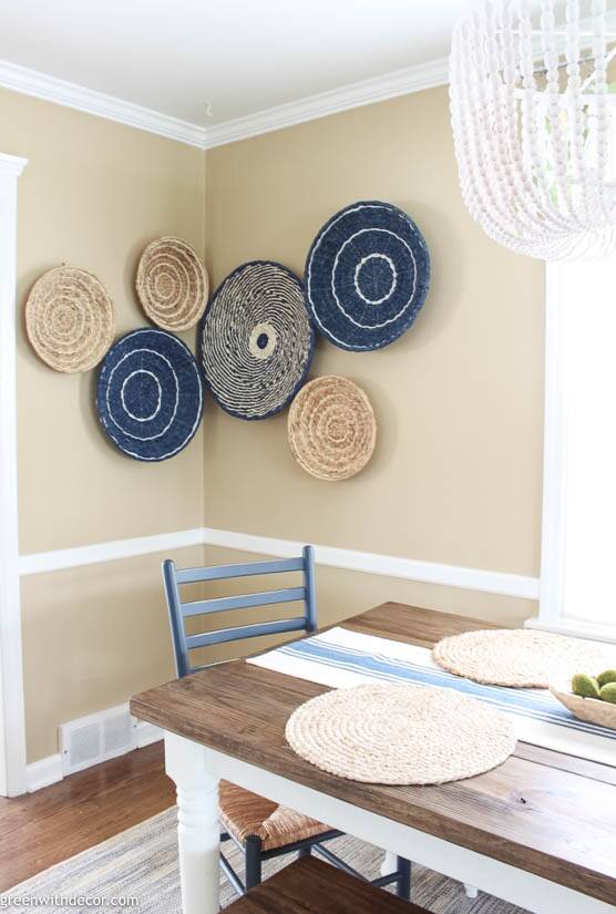Blue and tan seagrass basket gallery wall with a white beaded chandelier 
