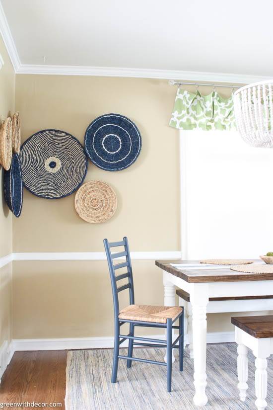 Boho coastal farmhouse dining room with a seagrass basket gallery wall