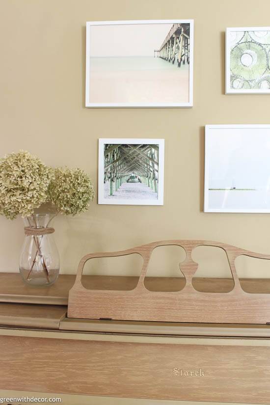 Beachy photos in a gallery wall above a piano