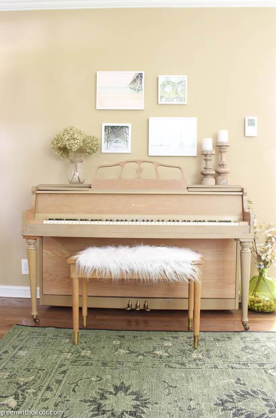 Beachy gallery wall above a piano