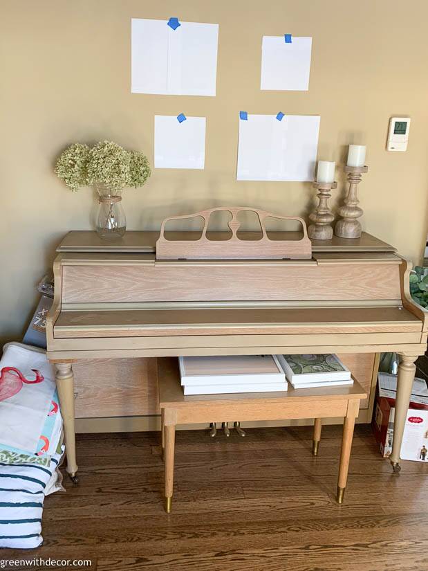 Paper outlining a gallery wall above a piano