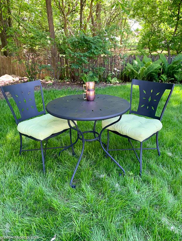 A painted bistro set with green cushions