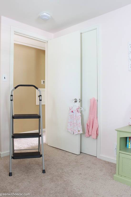 Nursery with pink walls and white doors