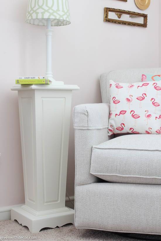 A repurposed plant stand used as a side table