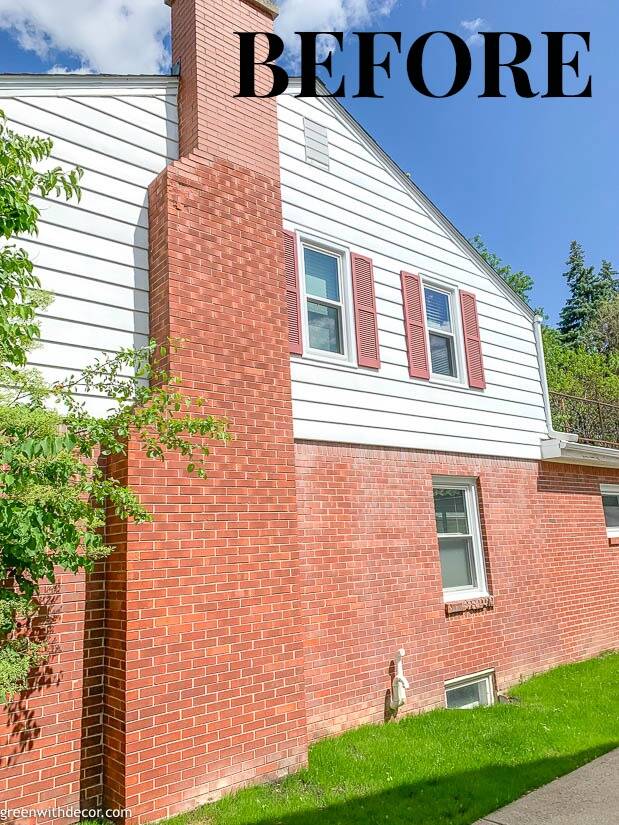 A before shot of a brick house with red shutters